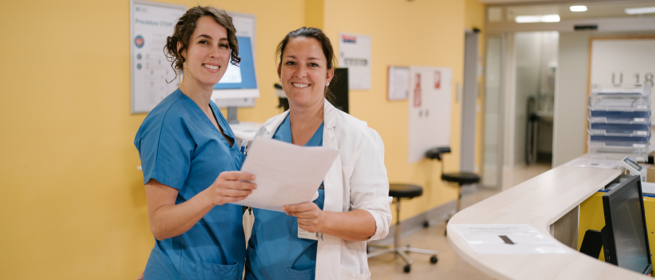 Foto einer lächelnden Pflegekraft und eines Arztes mit einer Patientenakte in der Hand